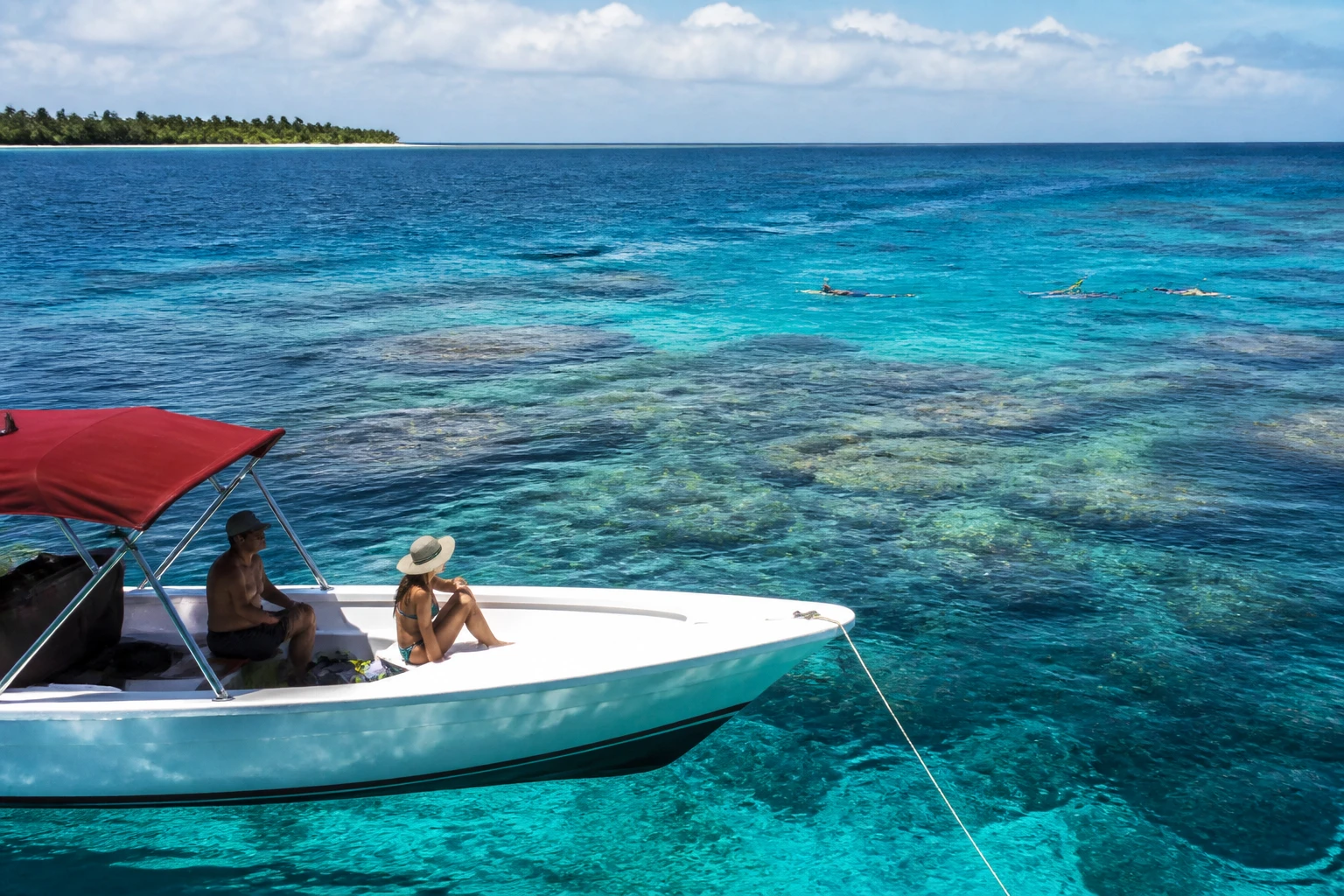 Boat and snorkelers near Belize’s coral reef
