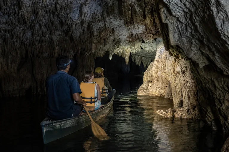 A guided canoe entering Barton Creek Cave in Belize