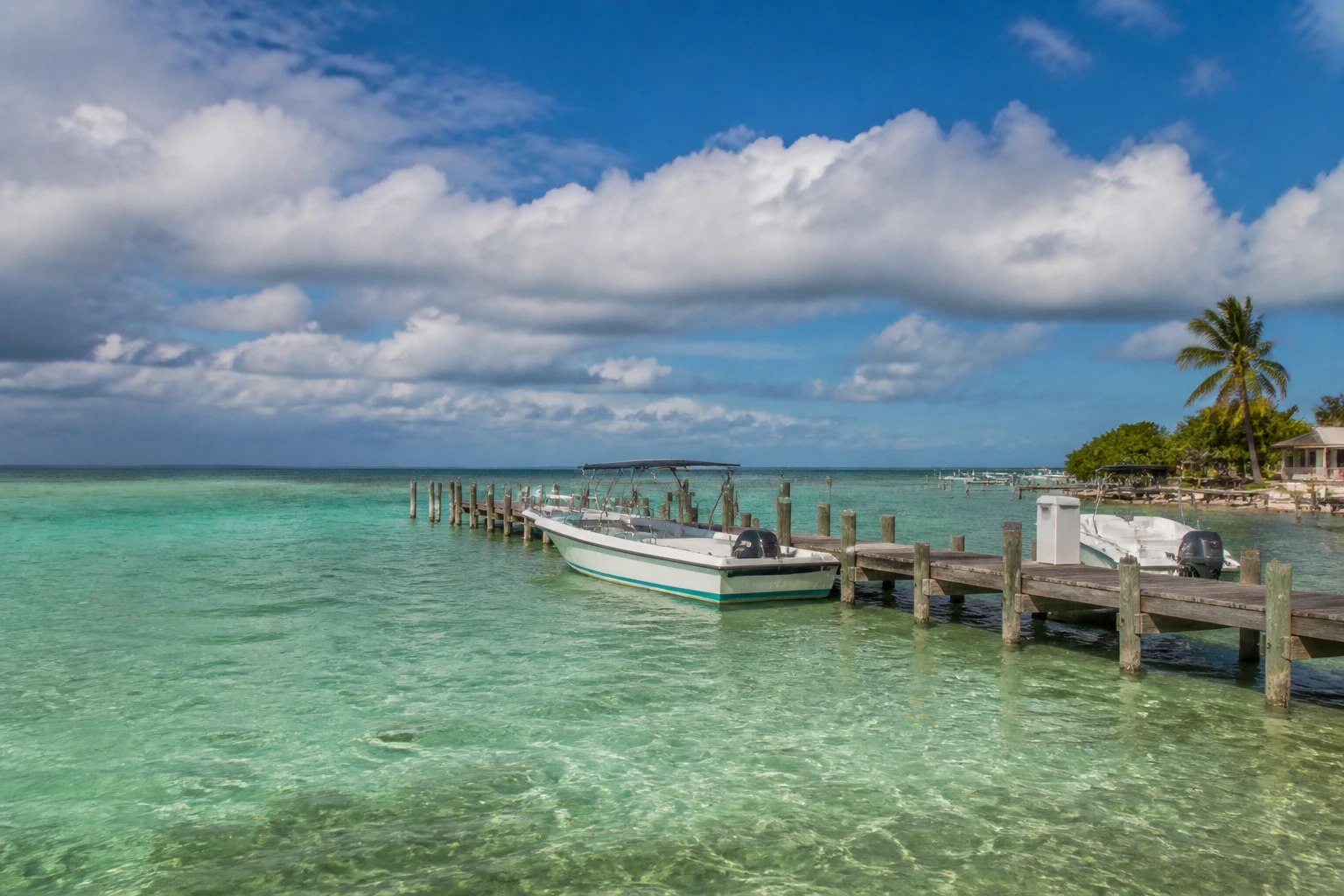 Belize island dock beneath changing fall weather