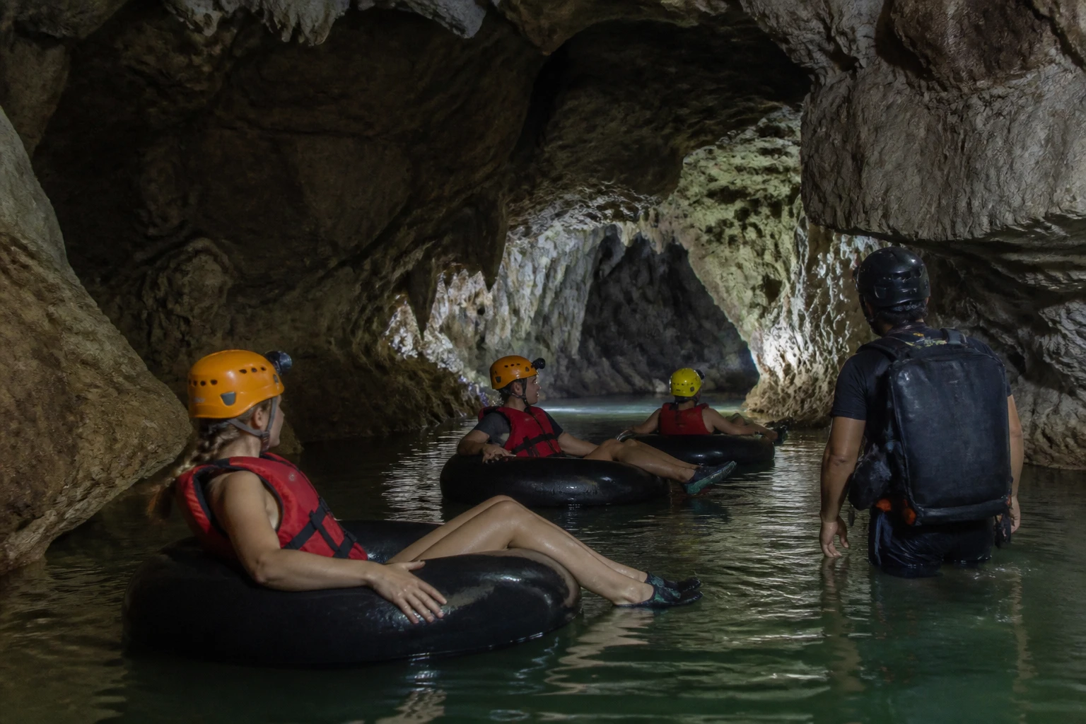 Cave tubing group during a Belize zipline and cave adventure