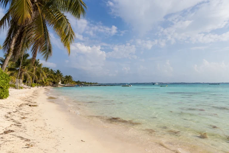 Sandy Caribbean shoreline and turquoise water in Belize