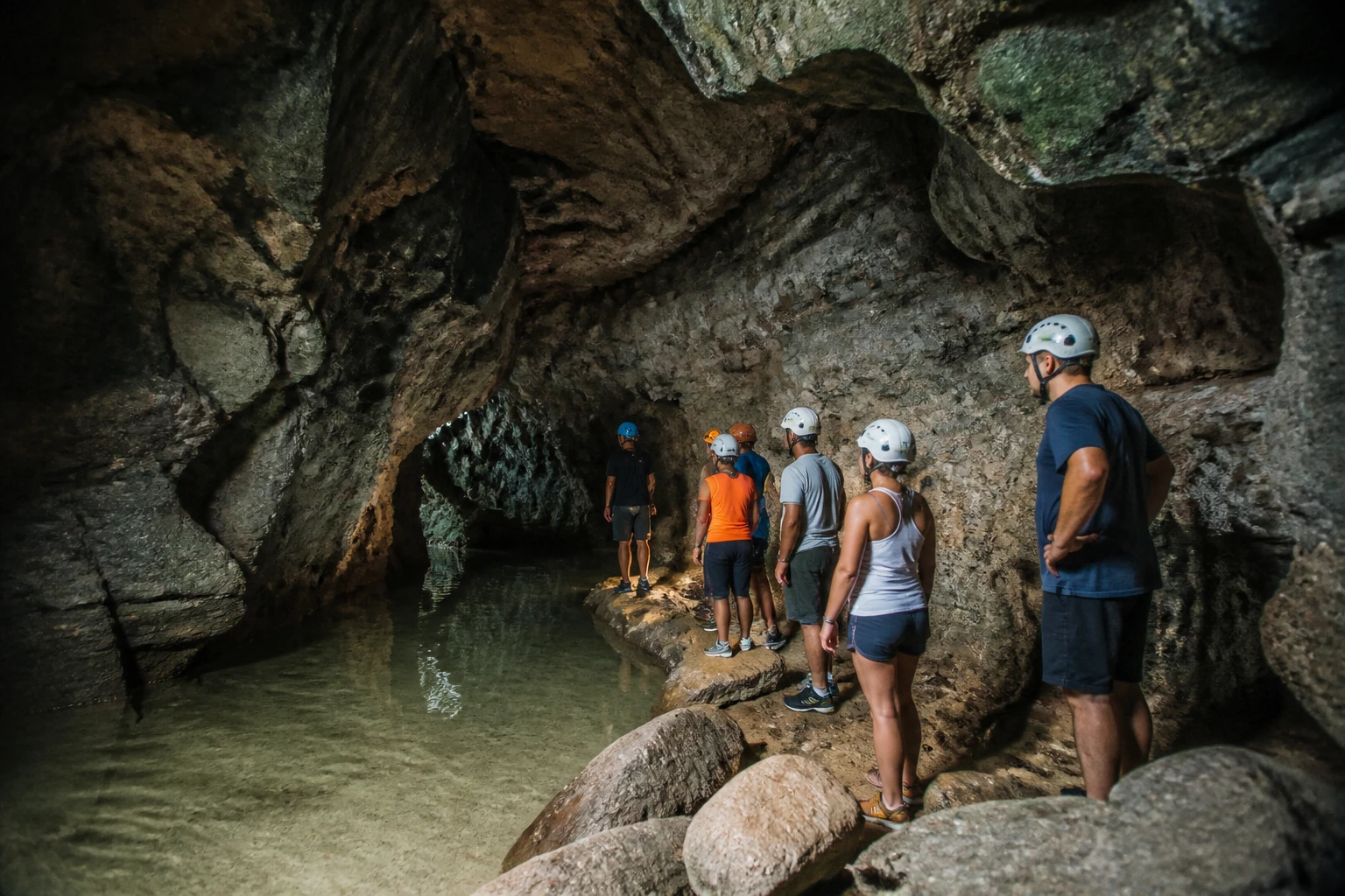 Guided cave adventure beside water in Belize