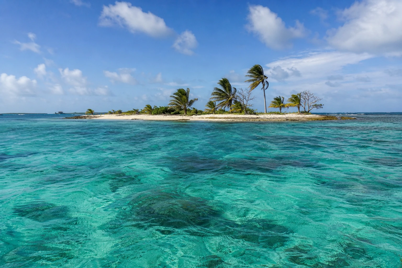 Turquoise water and sandy shoreline at Laughing Bird Caye near Placencia, Belize