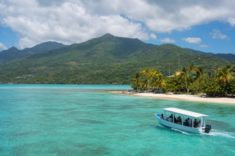 Caribbean water and green mainland scenery illustrating where to stay in Belize