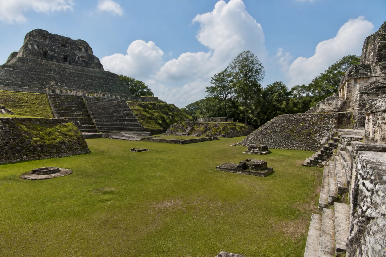 Stone structures surrounding a plaza at Xunantunich